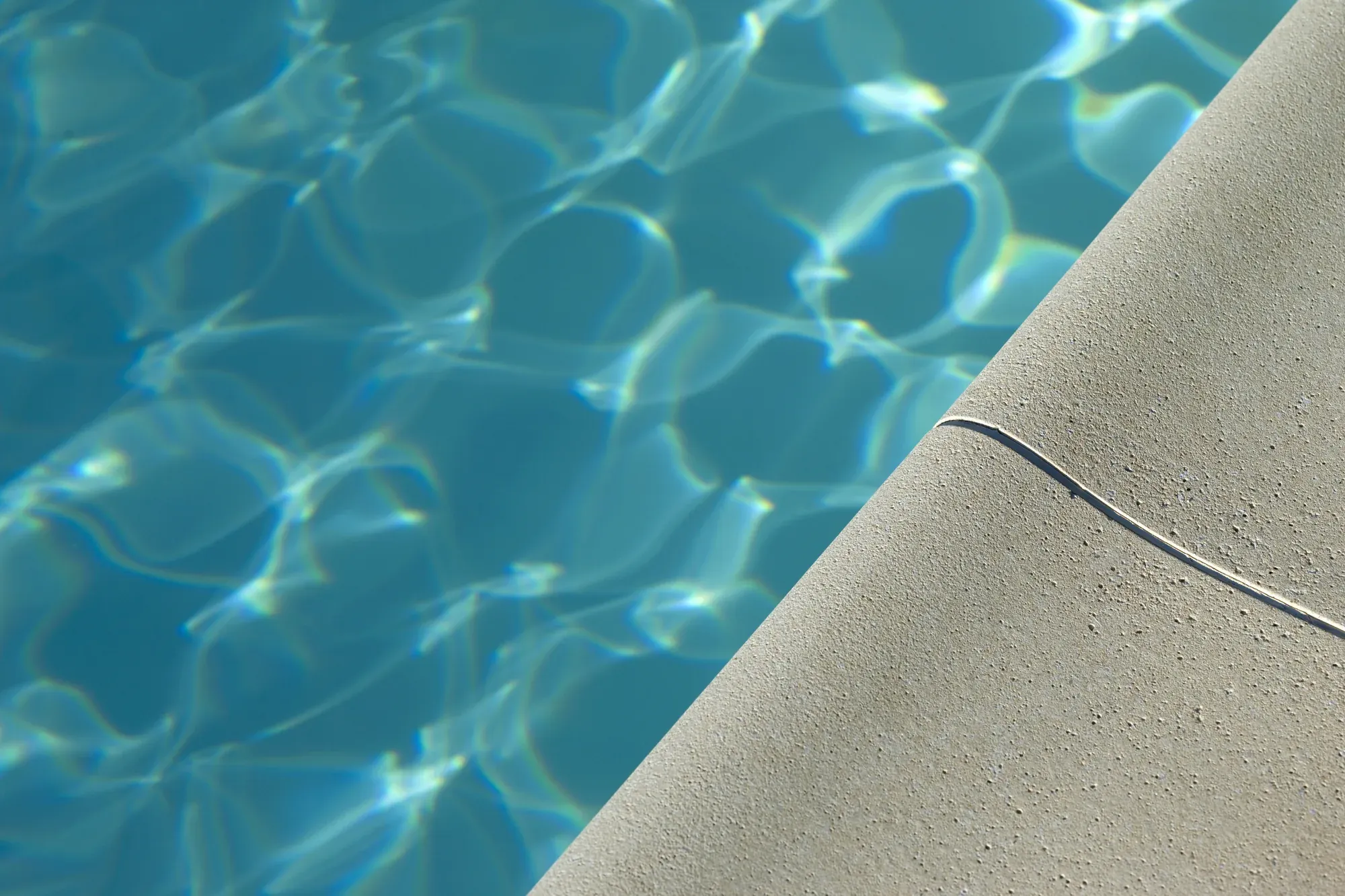 Close-up of pool coping along the waterline at a Naples pool