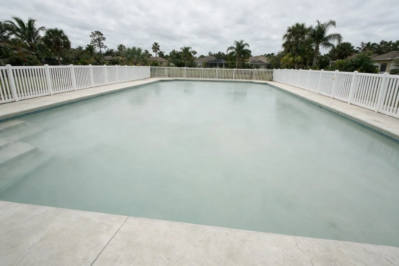 Cloudy pool water mid-recovery in Naples