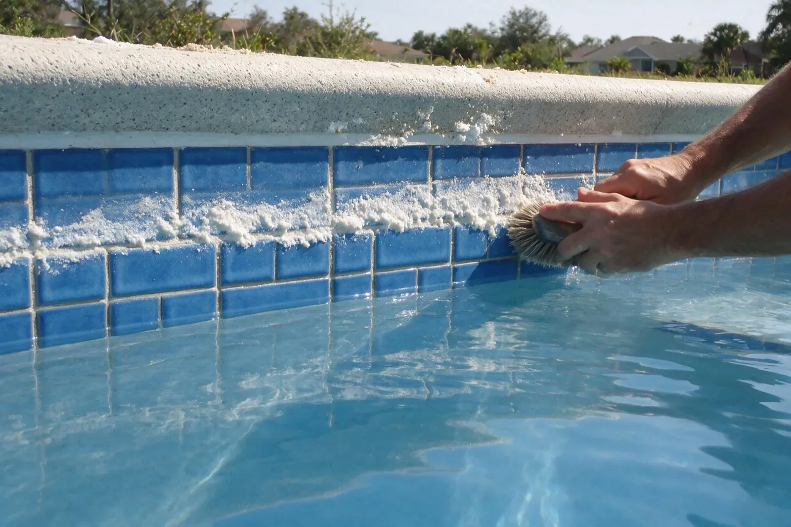 Scrubbing mineral scale off waterline tile in Bonita Springs